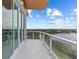 A modern condo balcony with glass railings providing stunning views and seamless indoor-outdoor flow at 1020 Sunset Point Rd # 712, Clearwater, FL 33755