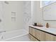 Bright bathroom featuring a tub with shower, marble accent wall, and modern vanity at 1020 Sunset Point Rd # 712, Clearwater, FL 33755