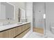 Modern bathroom with double vanity, sleek wood cabinets, and a glass-enclosed shower at 1020 Sunset Point Rd # 712, Clearwater, FL 33755