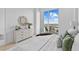 Bright bedroom with private balcony access, dresser, and a king bed at 1020 Sunset Point Rd # 712, Clearwater, FL 33755