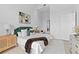 Bright bedroom offering hardwood floors, contemporary décor, and a green velvet headboard at 1020 Sunset Point Rd # 712, Clearwater, FL 33755