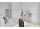 Bright bedroom with an ensuite bathroom and view into the kitchen at 1020 Sunset Point Rd # 712, Clearwater, FL 33755