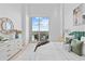 Bright bedroom with private balcony access, dresser, and a king bed at 1020 Sunset Point Rd # 712, Clearwater, FL 33755