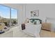 Bright bedroom with private balcony, a large bed, and two end tables at 1020 Sunset Point Rd # 712, Clearwater, FL 33755