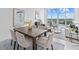 Bright, open dining room area with modern table, chairs, and waterfront views at 1020 Sunset Point Rd # 712, Clearwater, FL 33755