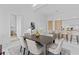 Open-concept kitchen and dining area with an elegant table set for six, marble floors, and high-end appliances at 1020 Sunset Point Rd # 712, Clearwater, FL 33755
