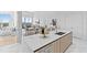 Bright, open kitchen with modern island, stainless steel appliances, and seamless flow to the dining and living areas at 1020 Sunset Point Rd # 712, Clearwater, FL 33755