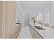 Modern kitchen with white marble floors, an island with bar seating, and upscale appliances for culinary enthusiasts at 1020 Sunset Point Rd # 712, Clearwater, FL 33755