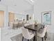 Modern kitchen and dining room area with marble flooring, stainless appliances, and contemporary decor at 1020 Sunset Point Rd # 712, Clearwater, FL 33755