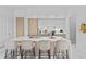 Stylish kitchen featuring a spacious island with bar seating, sleek white cabinets, and modern appliances at 1020 Sunset Point Rd # 712, Clearwater, FL 33755