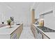 Contemporary kitchen with a quartz countertop, wood-paneled cabinets, and a modern gas range for gourmet cooking at 1020 Sunset Point Rd # 712, Clearwater, FL 33755
