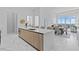 Open-concept kitchen featuring a large island with modern countertops and views of the dining and living area at 1020 Sunset Point Rd # 712, Clearwater, FL 33755
