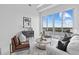 A bright living room area with comfortable seating, large windows, and waterfront views at 1020 Sunset Point Rd # 712, Clearwater, FL 33755