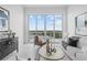 A bright living room area with comfortable seating, large windows, and waterfront views at 1020 Sunset Point Rd # 712, Clearwater, FL 33755