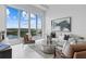 Living room with stunning views through large windows and stylish modern furniture at 1020 Sunset Point Rd # 712, Clearwater, FL 33755