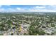 Wide aerial view of a vacant lot in a verdant neighborhood, under a partly cloudy sky at 1201 35Th N Ave, St Petersburg, FL 33704