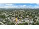 An aerial shot showcasing a vacant lot in a neighborhood with distant views of a city skyline and ocean at 1201 35Th N Ave, St Petersburg, FL 33704