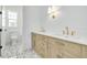 Elegant bathroom with double sinks, wooden cabinets, and decorative floor tiling at 1201 35Th N Ave, St Petersburg, FL 33704