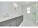 Modern bathroom with double vanities, gold fixtures, and a glass-enclosed shower at 1201 35Th N Ave, St Petersburg, FL 33704