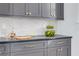 Stylish kitchen with gray cabinets, subway tile backsplash, and gold hardware at 1201 35Th N Ave, St Petersburg, FL 33704
