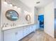 Bright bathroom features double vanities, modern fixtures, and wood-look tile flooring at 12010 Jackson Landing Pl, Tampa, FL 33624