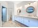 Bright bathroom features double vanities, modern fixtures, and wood-look tile flooring at 12010 Jackson Landing Pl, Tampa, FL 33624