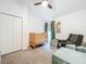 Bedroom with crib, comfortable chair and footstool, closet, and ceiling fan at 12010 Jackson Landing Pl, Tampa, FL 33624