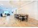 Open-concept dining area featuring a dining table with seating for eight and modern light fixture at 12010 Jackson Landing Pl, Tampa, FL 33624