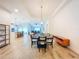 Open-concept dining area with modern light fixture, open to kitchen and living space at 12010 Jackson Landing Pl, Tampa, FL 33624