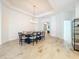 Elegant dining room with modern table setting, decorative light fixture, and seamless flooring at 12010 Jackson Landing Pl, Tampa, FL 33624