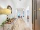 Bright hallway with wood-look tile flooring, arched doorways, and console table with decor at 12010 Jackson Landing Pl, Tampa, FL 33624