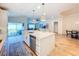 Bright kitchen with large island, white cabinets, stainless steel appliances and backyard views at 12010 Jackson Landing Pl, Tampa, FL 33624