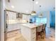 Kitchen featuring an island with seating, stainless steel appliances, and modern pendant lights at 12010 Jackson Landing Pl, Tampa, FL 33624
