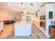 Well-lit kitchen with island seating, stainless steel appliances, and a seamless flow to the dining area at 12010 Jackson Landing Pl, Tampa, FL 33624
