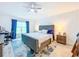 Main bedroom features a plush bed, ceiling fan, and serene atmosphere at 12010 Jackson Landing Pl, Tampa, FL 33624