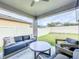 Inviting covered patio with comfortable seating, perfect for outdoor relaxation at 12010 Jackson Landing Pl, Tampa, FL 33624