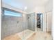 Walk-in shower features sleek tile, glass surround, and modern showerhead at 12010 Jackson Landing Pl, Tampa, FL 33624