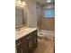 Bathroom with a large mirror, vanity with storage, and shower/tub combination at 12055 4Th E St, Treasure Island, FL 33706