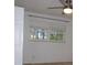 Bedroom featuring a ceiling fan and window with blinds at 12055 4Th E St, Treasure Island, FL 33706