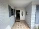 Charming entryway with tile floors, white brick, and muted blue shutters at 12055 4Th E St, Treasure Island, FL 33706