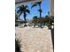 Spacious brick-paved driveway and tropical landscaping offer curb appeal at 12055 4Th E St, Treasure Island, FL 33706