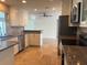 Well-lit kitchen featuring stainless appliances, granite counters, and an open design at 12055 4Th E St, Treasure Island, FL 33706