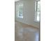 Bright, open room with large windows, neutral walls, and tile floors at 12055 4Th E St, Treasure Island, FL 33706