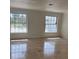 Bright living room featuring tile floors, neutral walls, and abundant natural light from large windows at 12055 4Th E St, Treasure Island, FL 33706