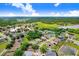 Aerial view of a residential area, with houses nestled among trees and adjacent to a lake at 1212 Baycove Ln, Lutz, FL 33549