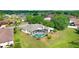 Aerial view of a home with screened-in pool, and lush landscaping at 1212 Baycove Ln, Lutz, FL 33549