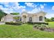 Beautiful curb appeal with manicured lawn, front door entrance and three-car garage at 1212 Baycove Ln, Lutz, FL 33549