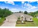 Stunning single-story home featuring manicured landscaping and an attached three car garage at 1212 Baycove Ln, Lutz, FL 33549