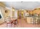 Bright kitchen and dining area features wood cabinets, tile flooring, and an inviting breakfast bar at 1212 Baycove Ln, Lutz, FL 33549