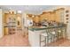 Well-equipped kitchen with an island, breakfast bar, and bright wooden cabinetry at 1212 Baycove Ln, Lutz, FL 33549